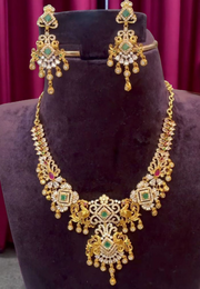 Traditional short necklace with ruby and green colour stones pairing with beautiful earrings